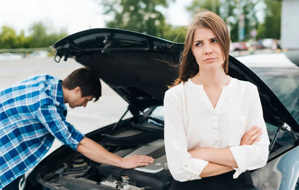 A damaged vehicle undergoing inspection to compare salvage vs rebuilt title standards