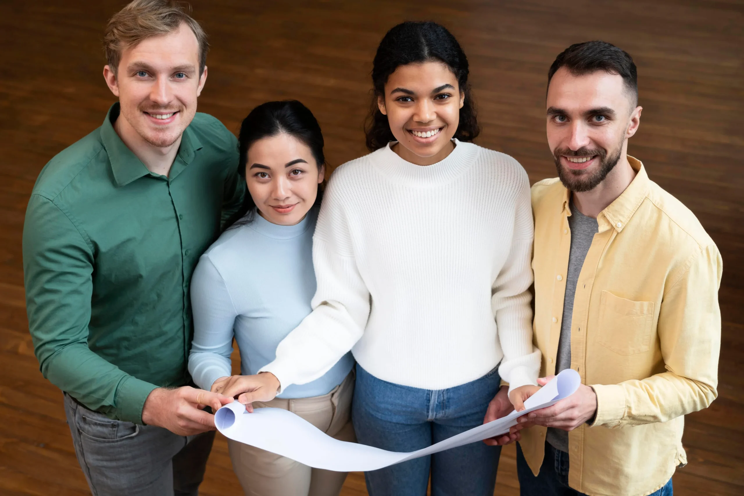 A diverse team of professionals working together and reviewing documents